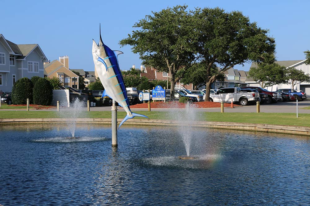 marlin statue by water fountains