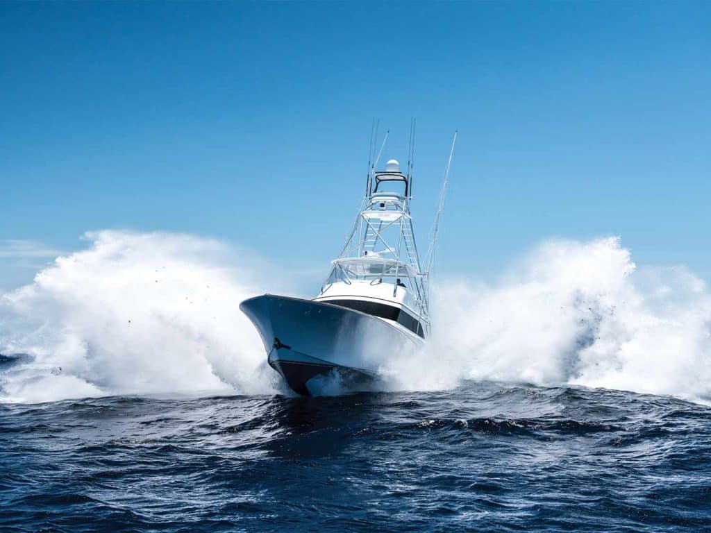 A large white sport fishing boat on the water.