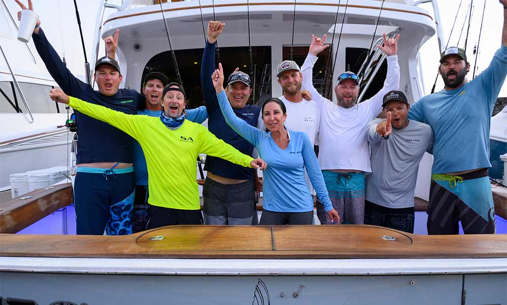 fishing team celebrating on boat deck