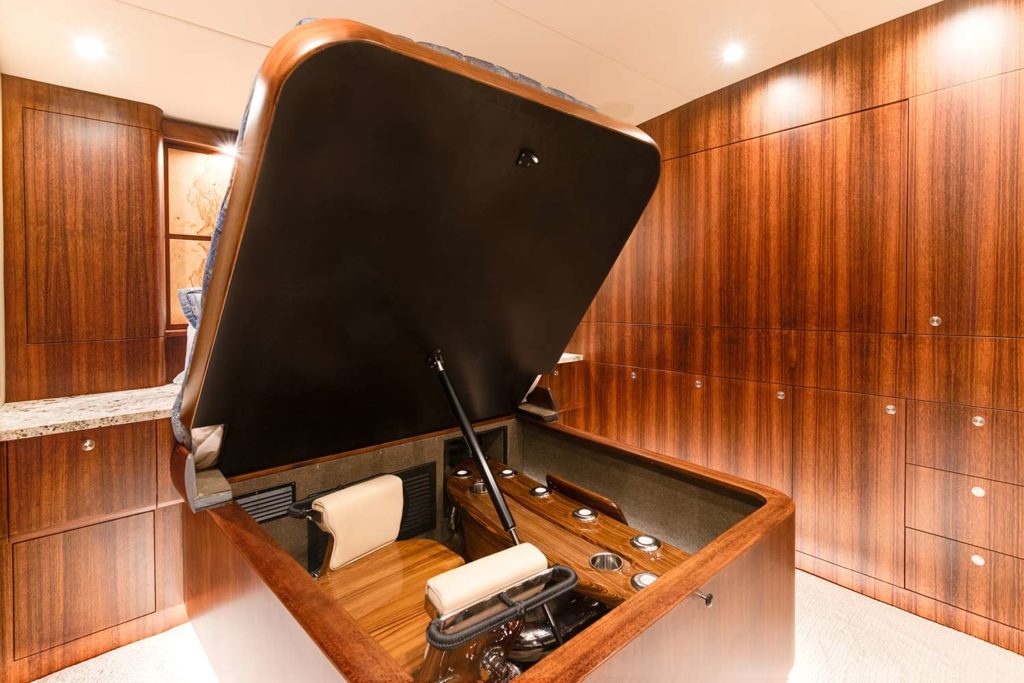 The hidden storage compartment under a bed of a Bayliss Boatworks sport fishing boat.