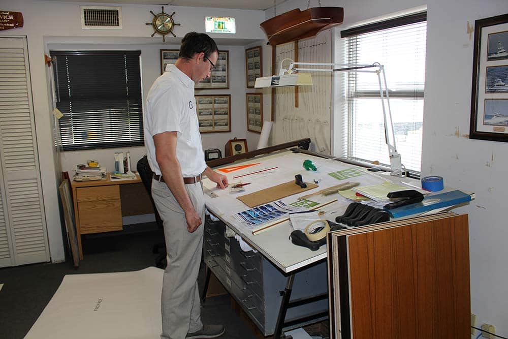 Dusty Rybovich looking at drawings for boat build