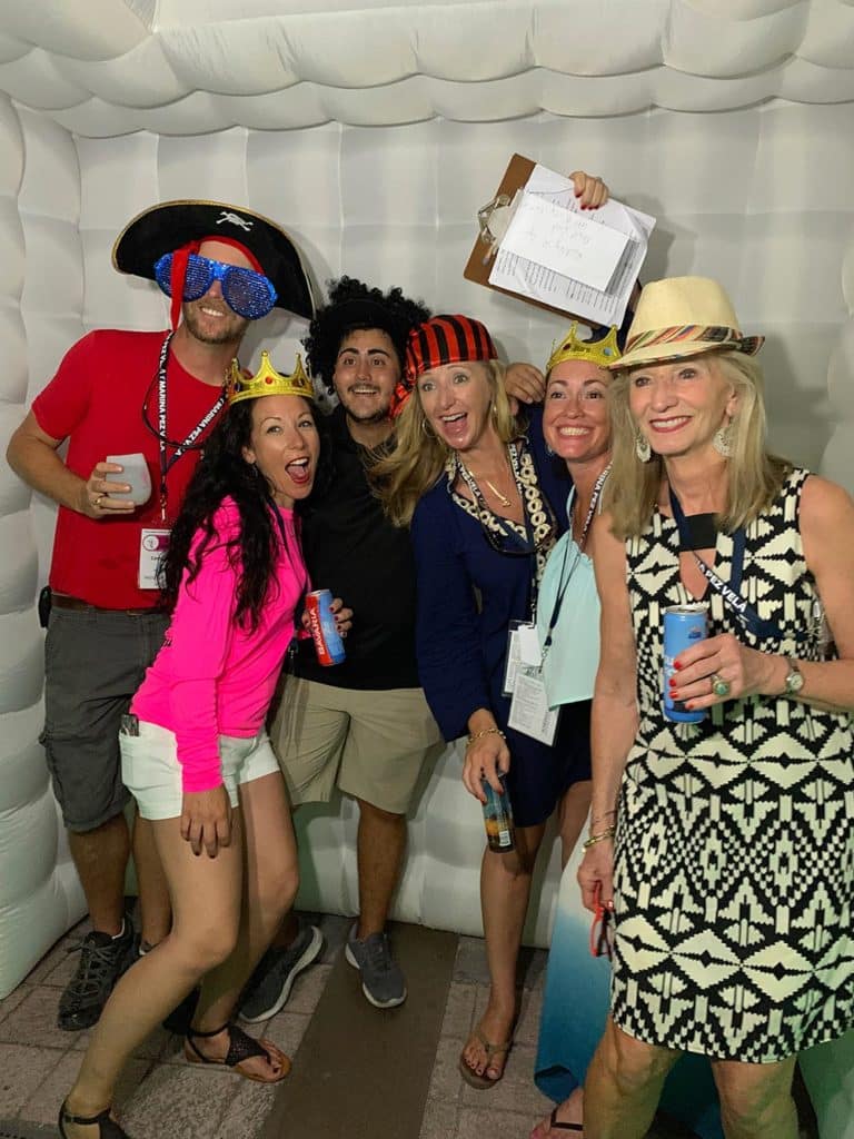 group of people partying in a photo booth