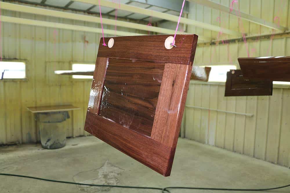 wooden plank hanging from wires
