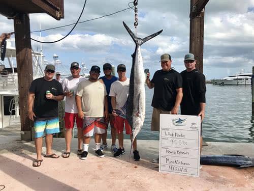 group photo of team miss victoria with their white marlin