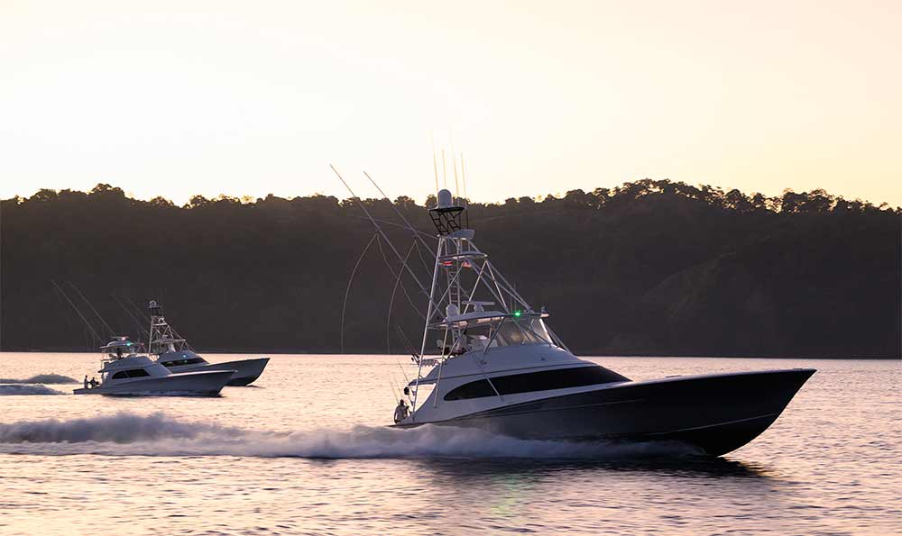 three boats on the water at sunset los suenos resort and marina