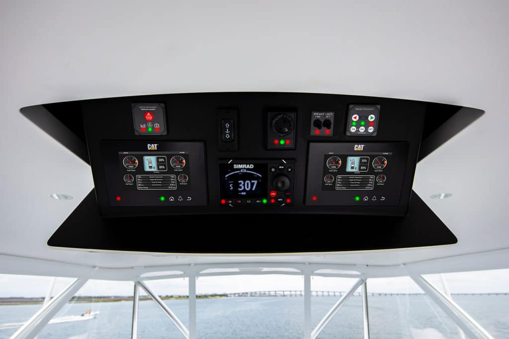 Engine display units hanging from the ceiling of a sport fishing boat helm.