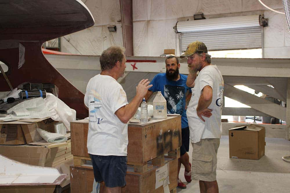 three boat builders meeting