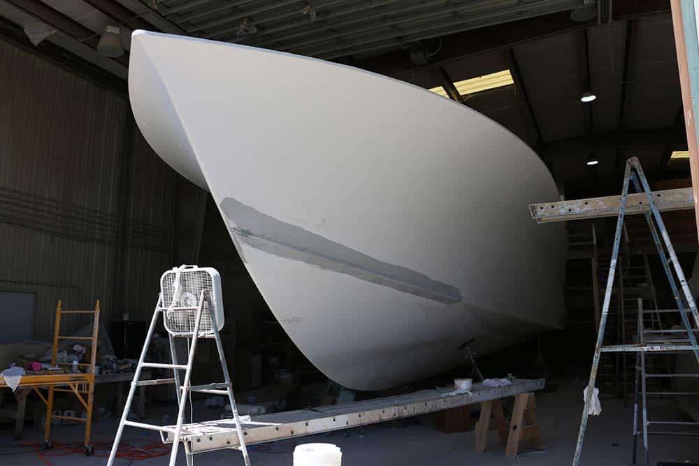 side angle view of yacht hull under construction