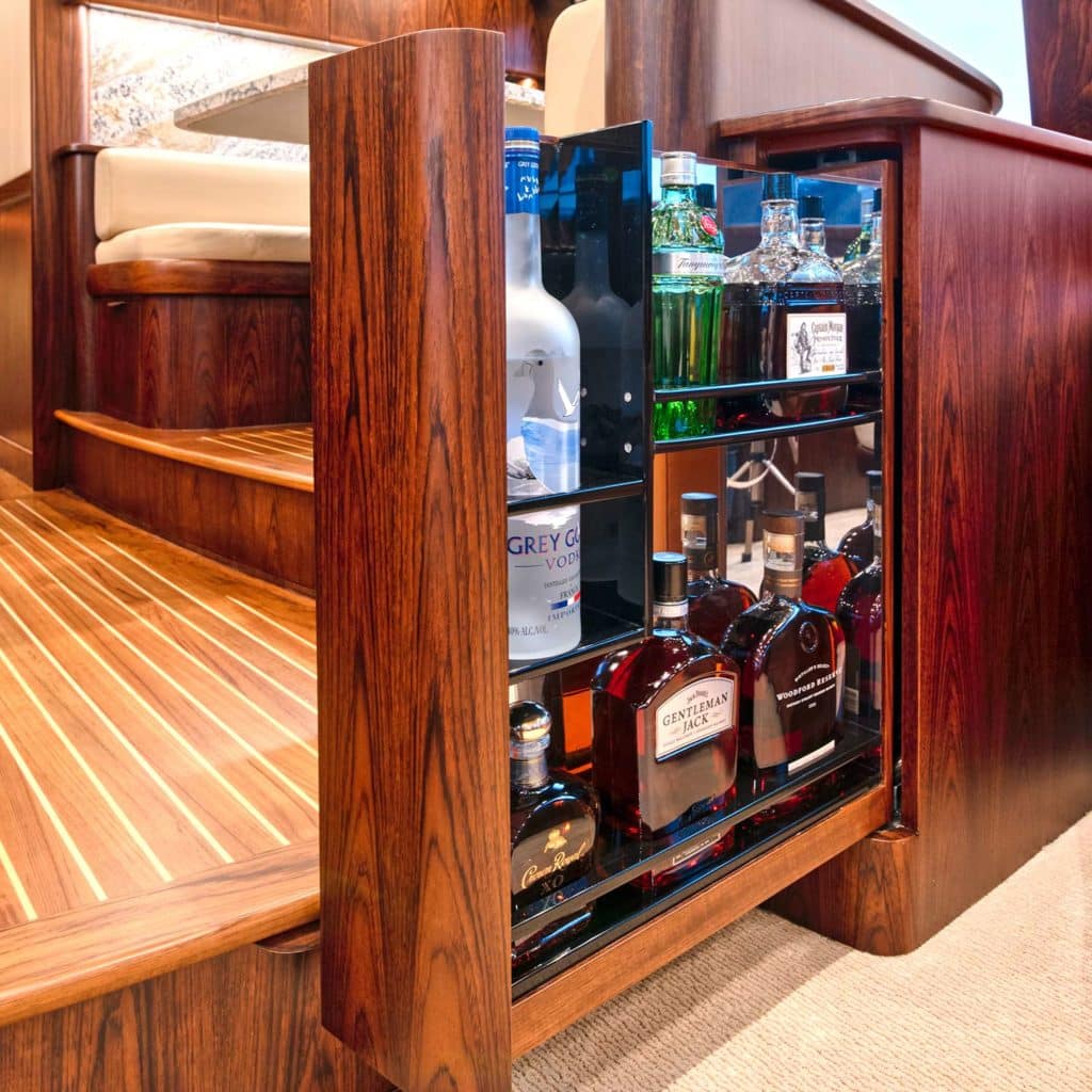 Pull-out liquor storage in the galley of a Bayliss Boatworks sport fishing boat.