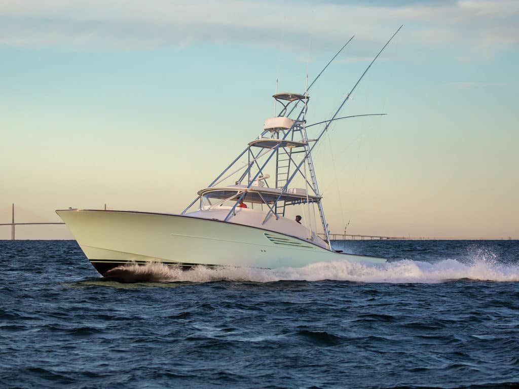 boat running with skyway bridge in background