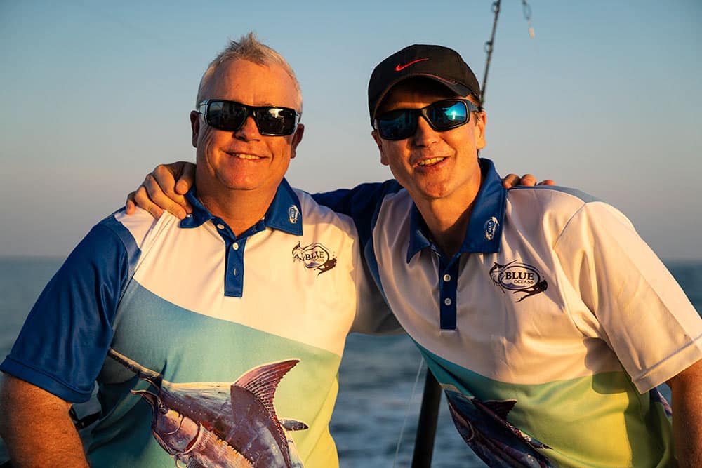 two men at sunset after fishing for marlin
