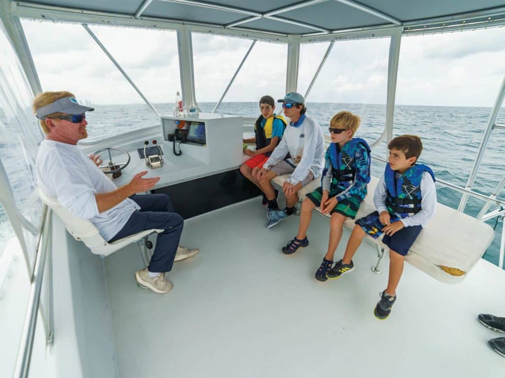 Capt. Mike Puller teaching kids how to fish.