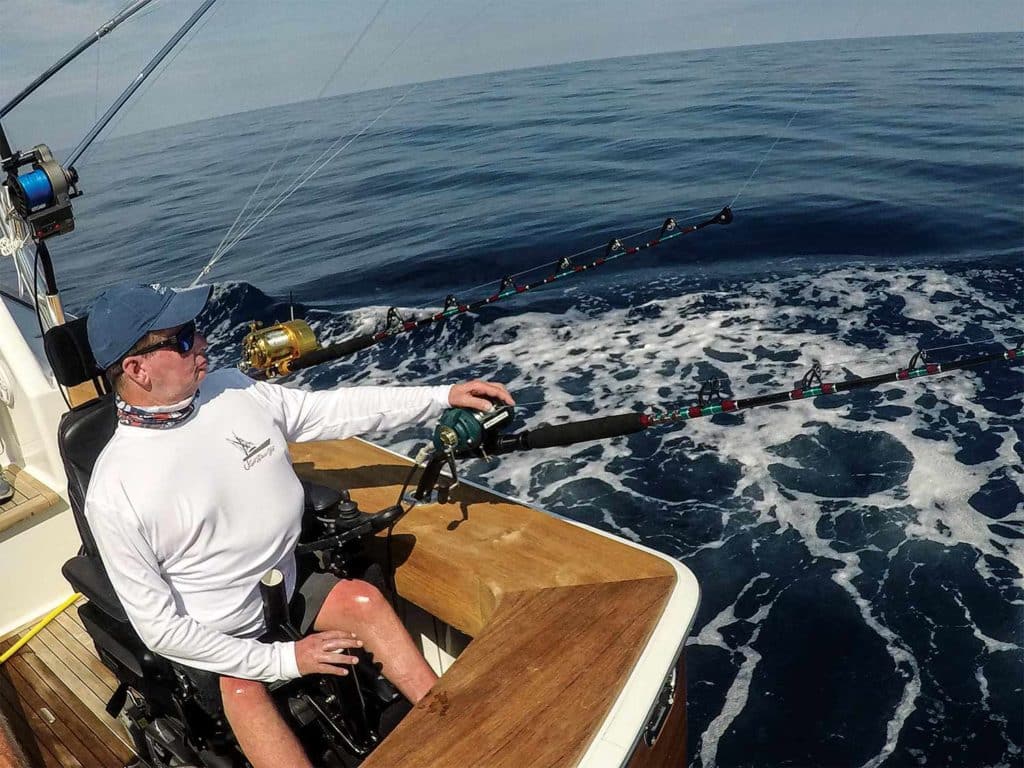 angler using electric reel for deep sea fishing