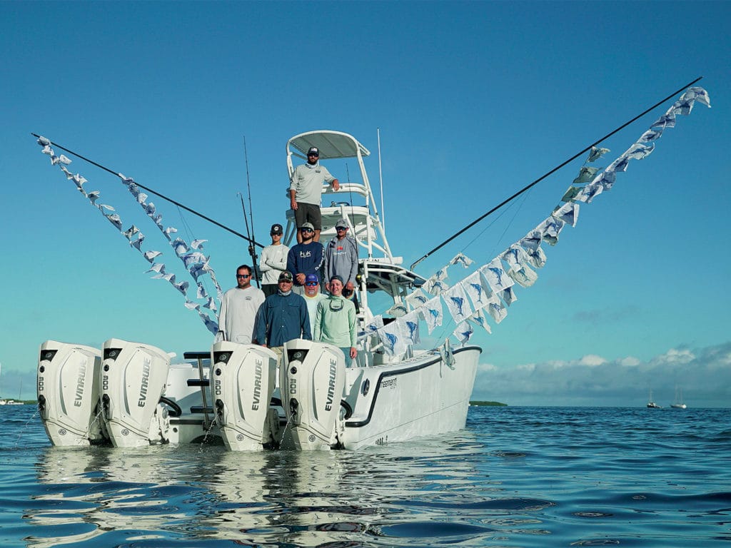 Anglers standing on the deck of an outboard sport fishing boat.
