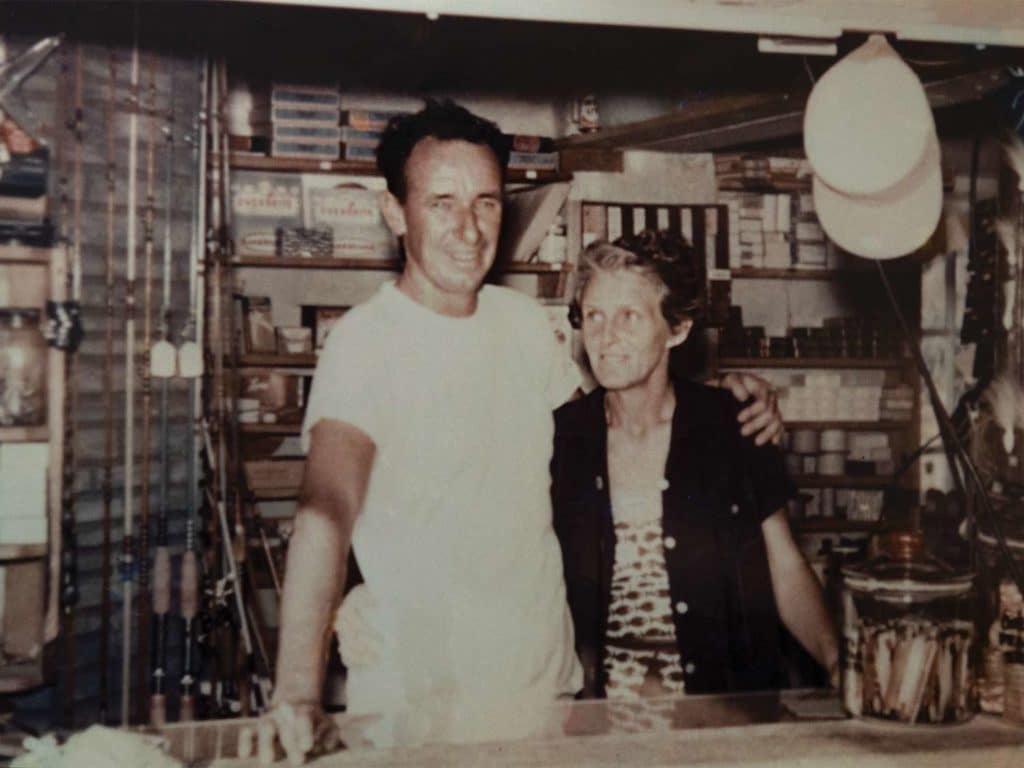 A vintage image of a man and a woman behind a counter.