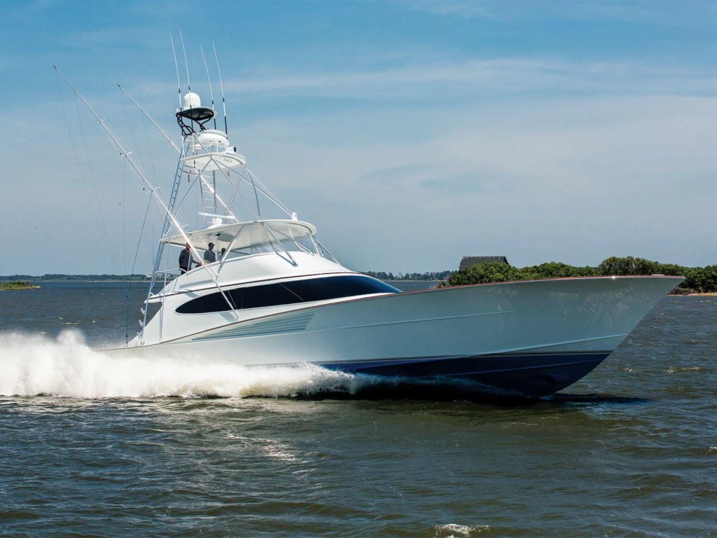 A white and blue sport fishing boat on the water.