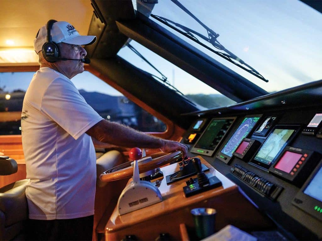 bill royster at the helm of a yacht