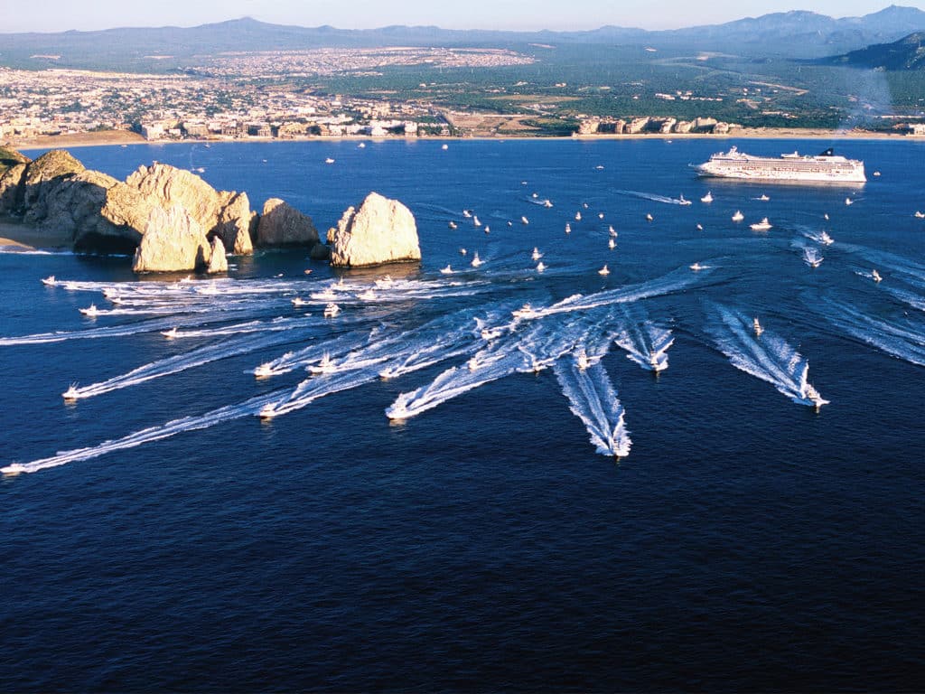 A swarm of sport-fishing boats leave the marina and coastline for a sport fishing tournament in Cabo San Lucas, Mexico.