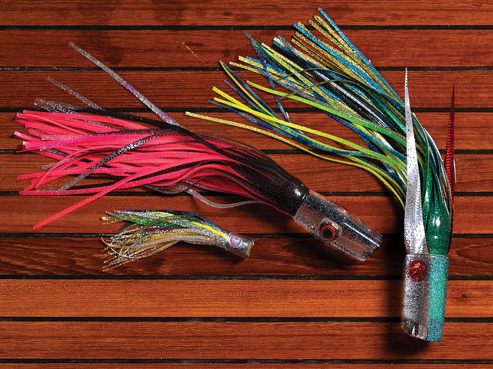 three blue marlin fishing lures on a wooden backdrop