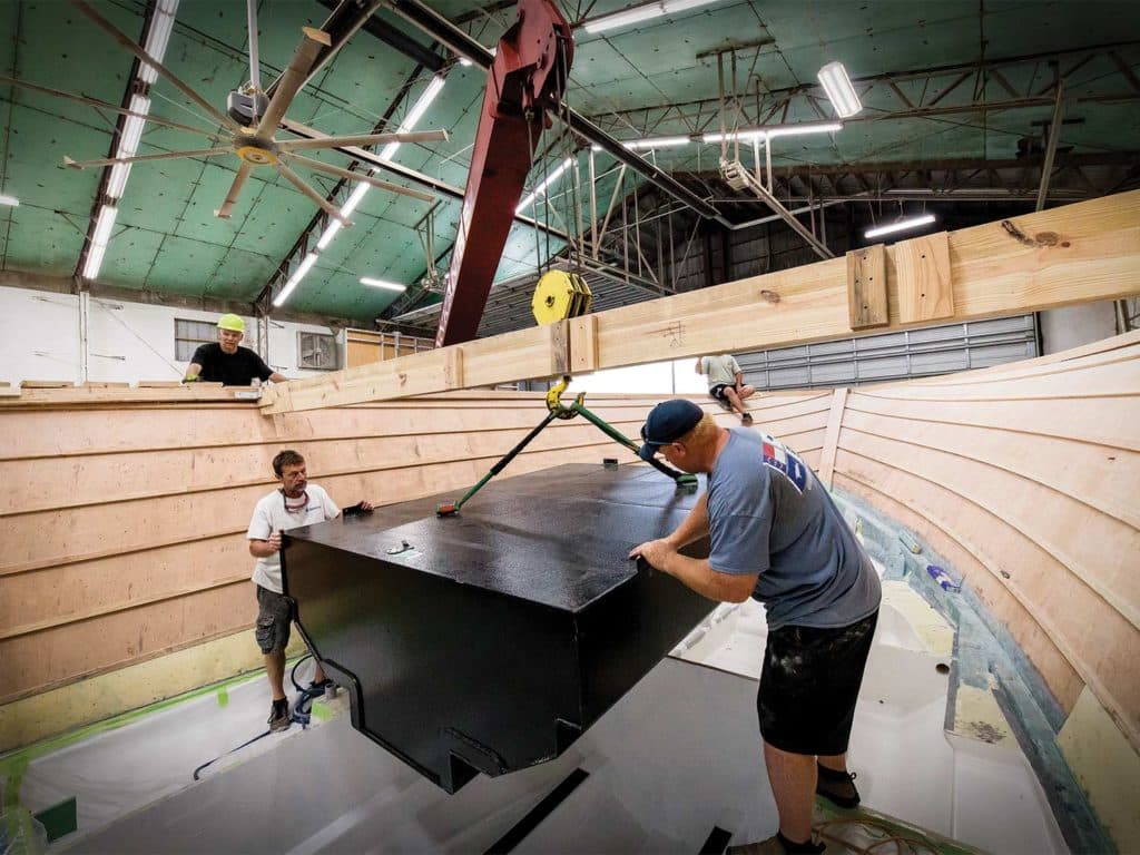 Boat builders in a warehouse.