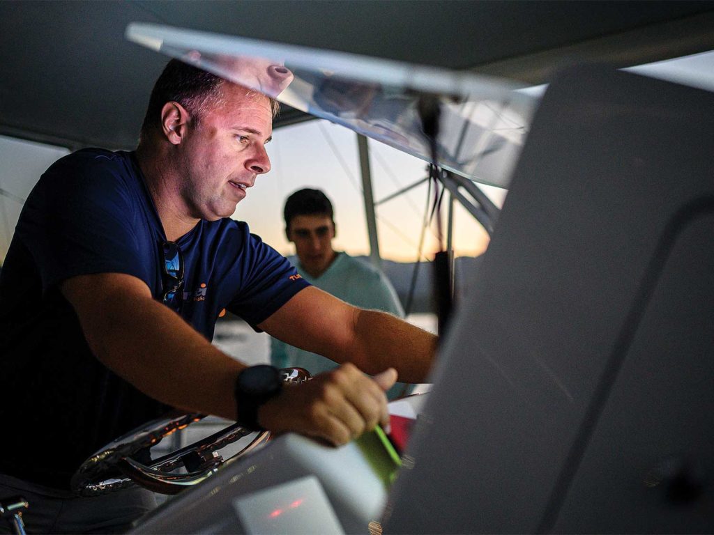 boat captain viewing boat helm electronics