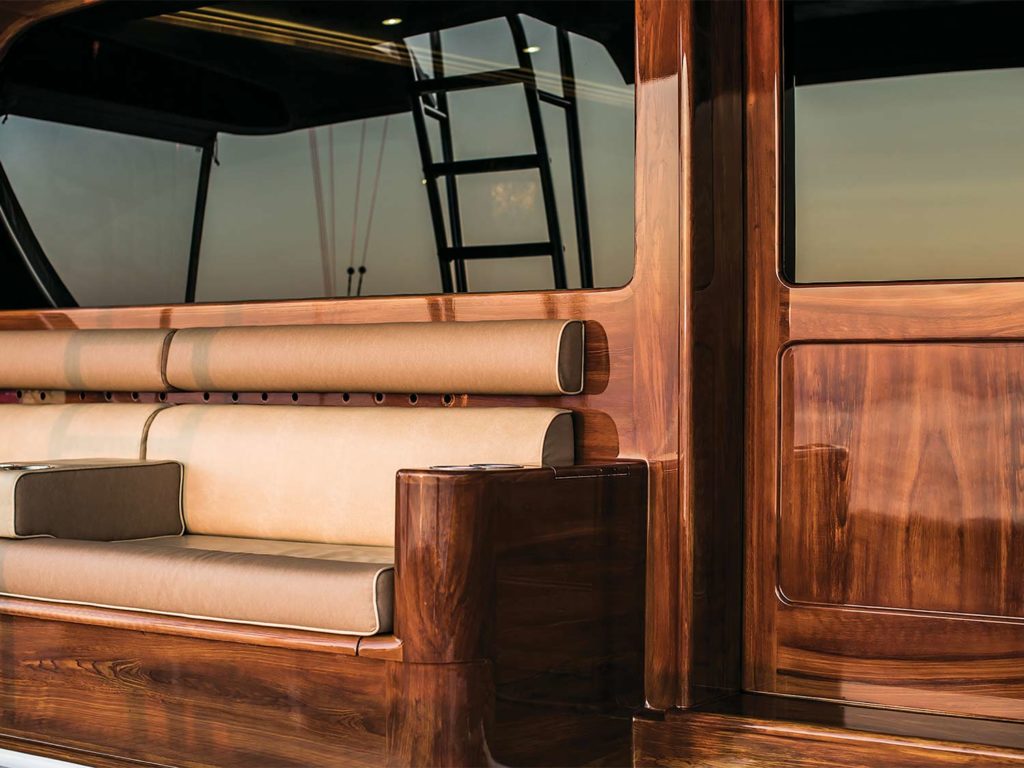 A sport fishing boat mezzanine built with faux teak and stained dark.