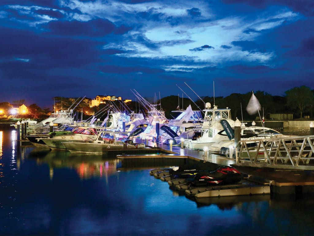 View of the Buenaventura marina lit up at night.