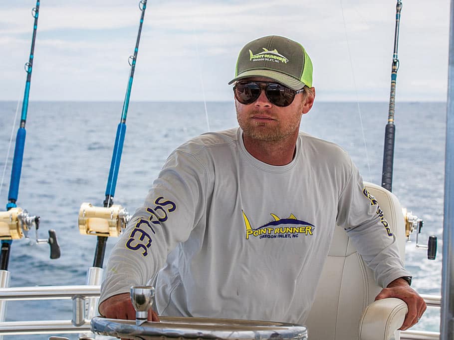 A sport fishing captain in a captains chair.