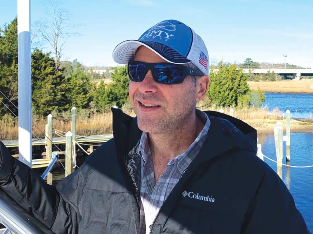 A man stands wearing sunglasses.