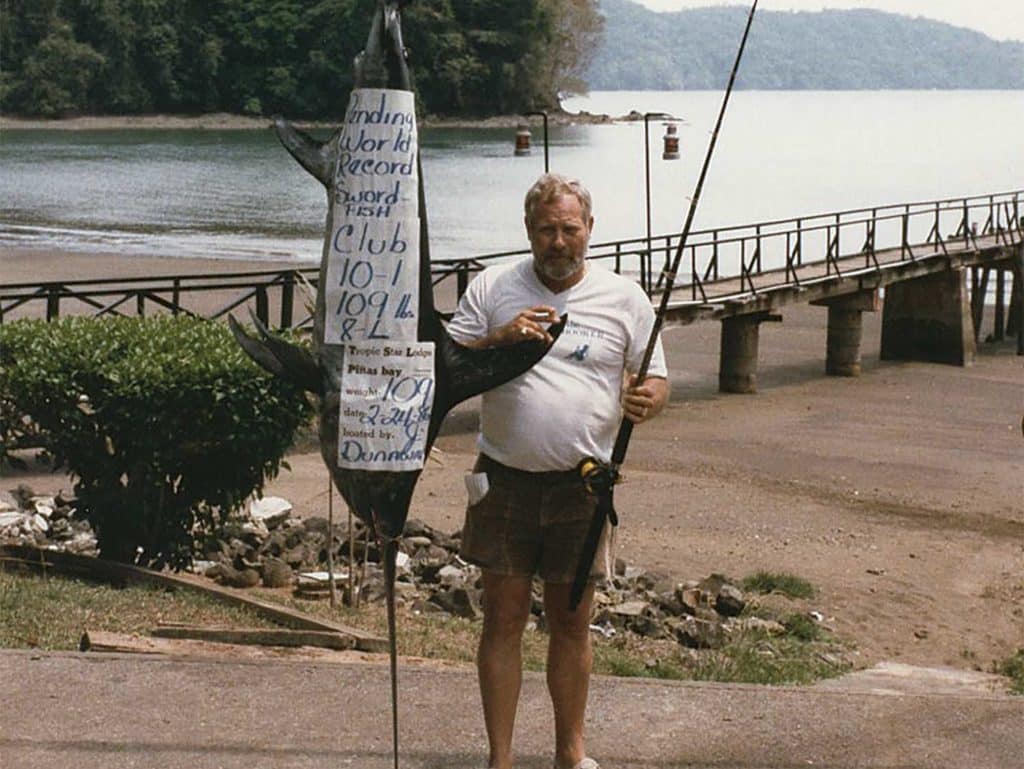 Jerry Dunaway poses next to a large swordfish.
