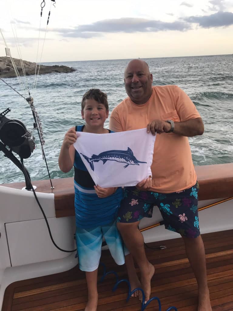 bruce and jeff cohen with blue marlin release flag