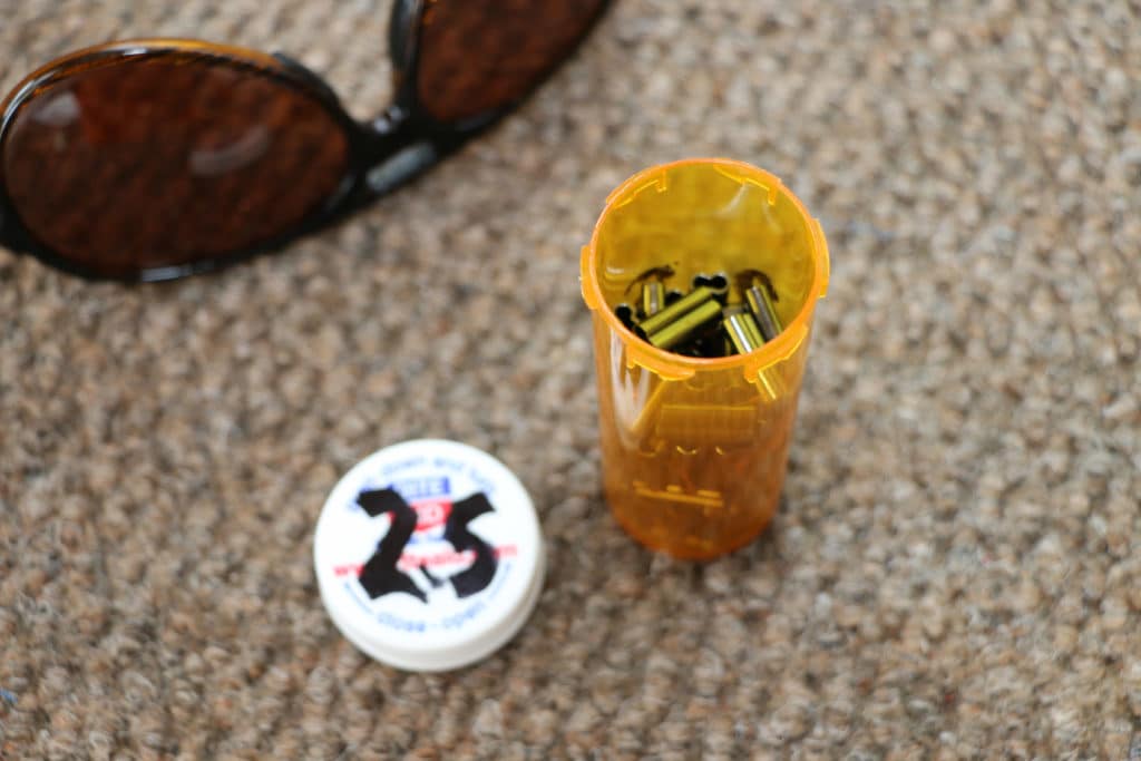 empty pill bottles used for fishing equipment storage