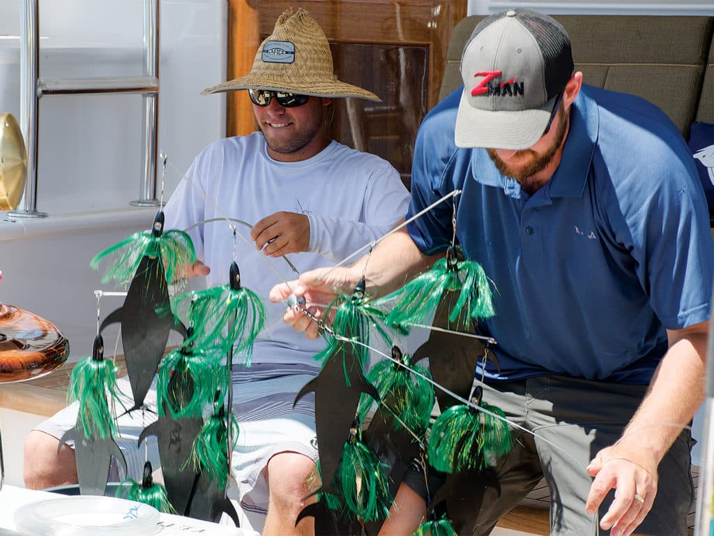 Two sport fishing anglers prepare dredges.