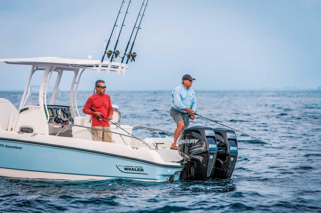 two men fishing on an outboard motor boat