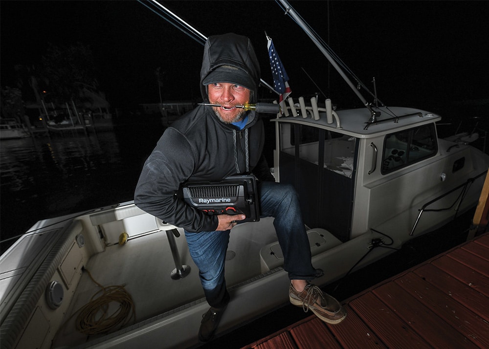 man stepping off of a boat at night