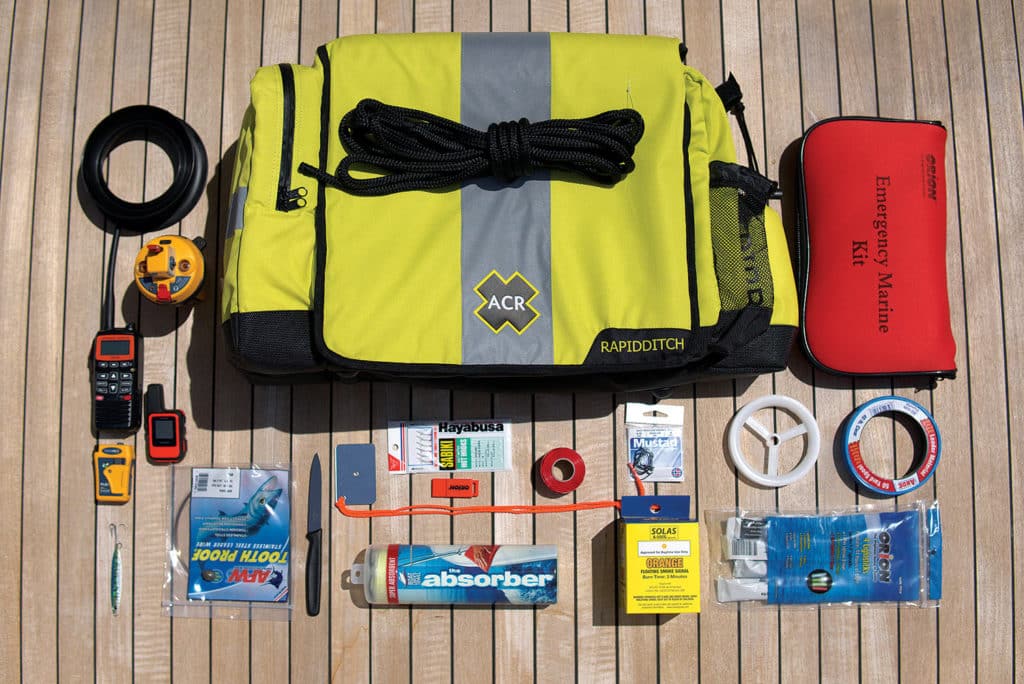 A bag and survival supplies on the deck of a boat.