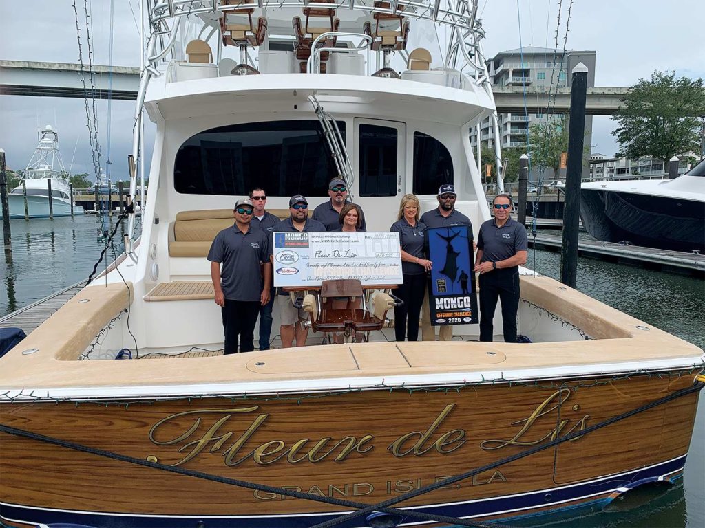 A fishing team standing on the deck of a boat.