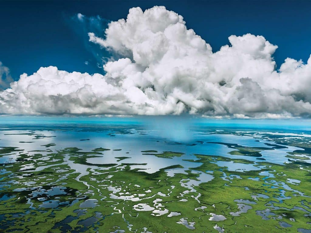 An aerial view of the Florida Everglades marshes and clouds.