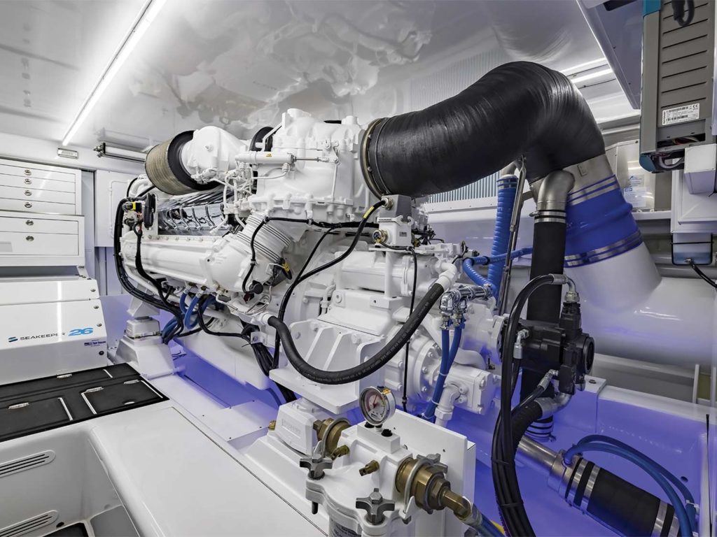 The stark, white, clean engine room of a sport-fishing boat.