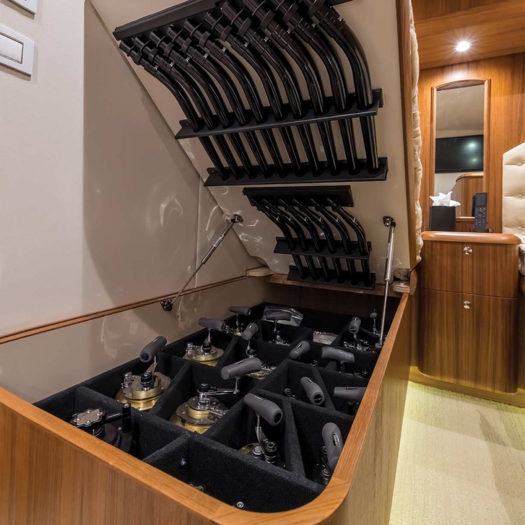 The interior rod storage of a sport fishing boat that's housed underneath a berth in a stateroom.