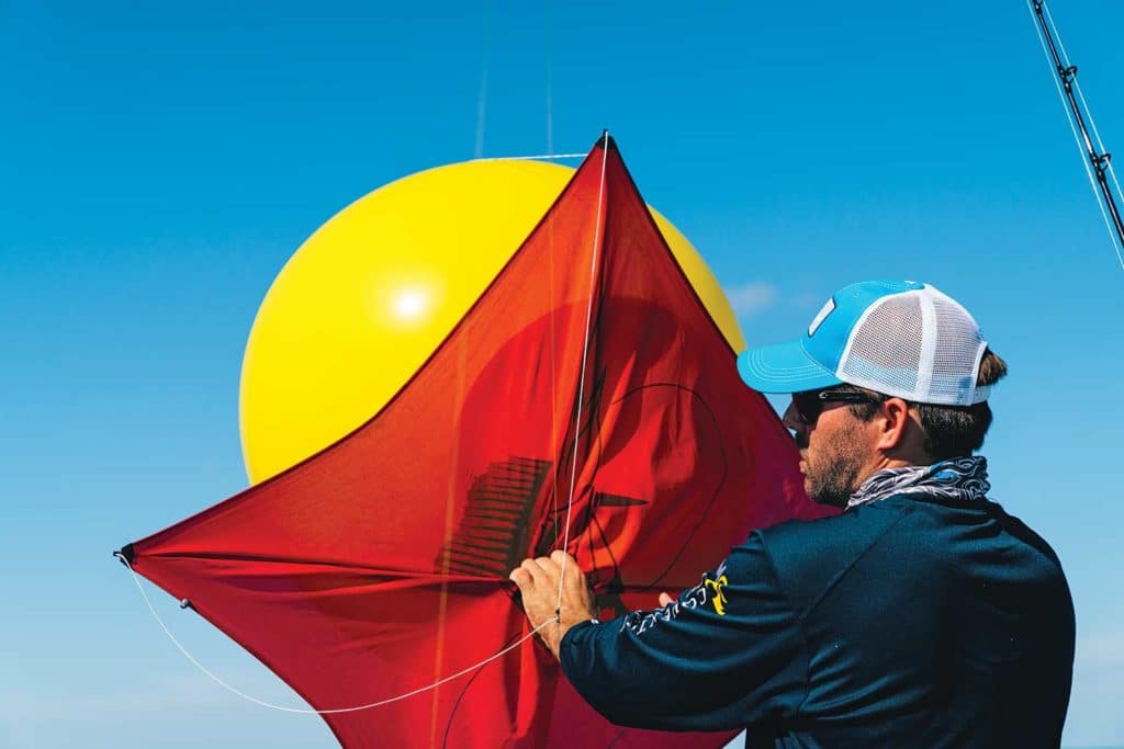 Angler preparing kite and helium balloon.