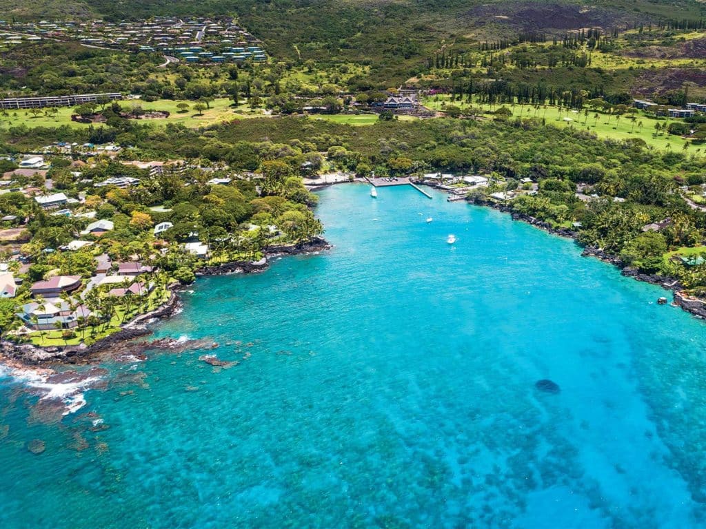 The coastline of Kona, Hawaii. Docks and buildings line the coastline.