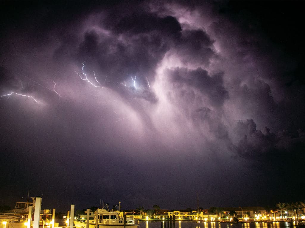 A lightning storm over a boat marina.