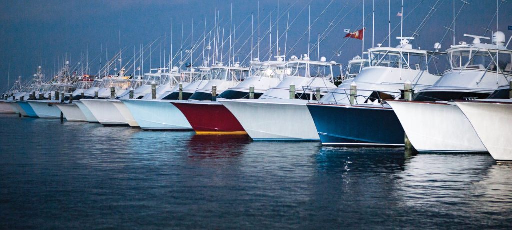 line up of fishing boats with painted hulls