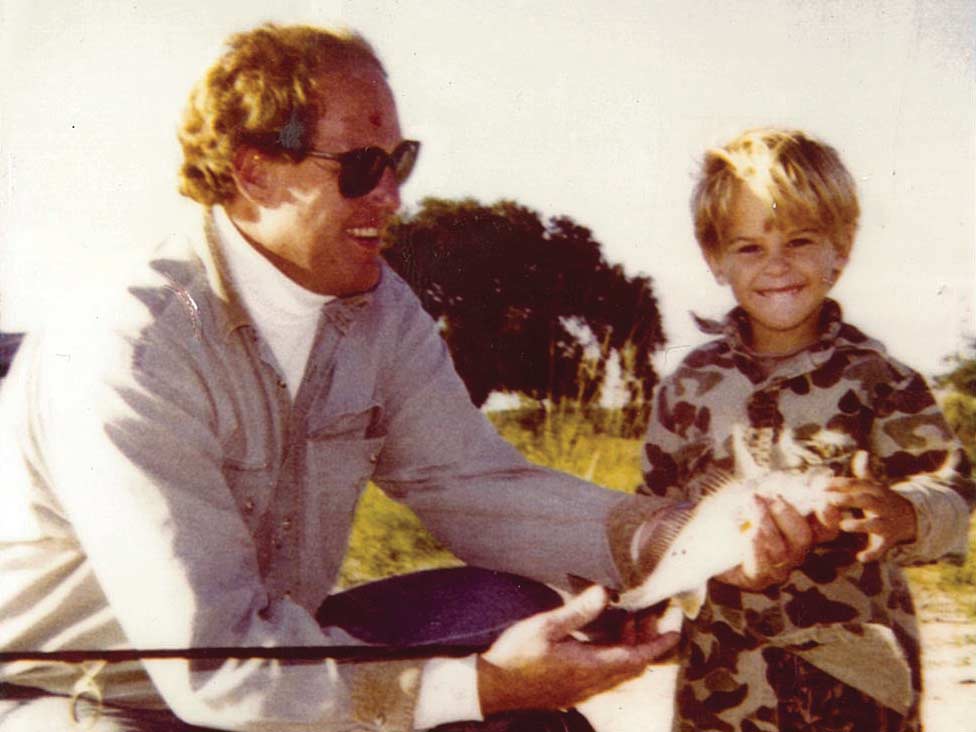 Vintage photo of a man and child fishing.