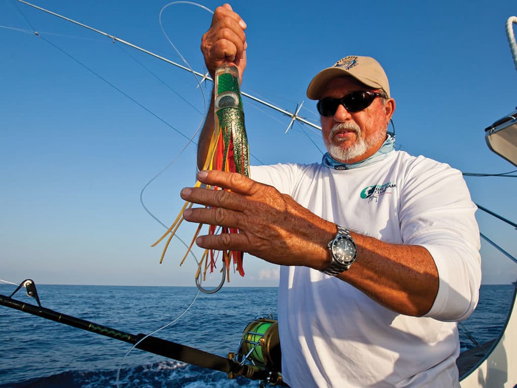 capt billy black holding up a lure