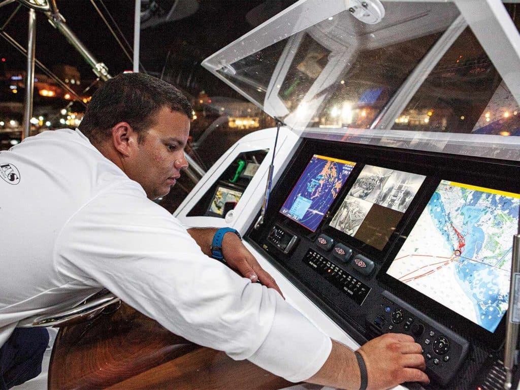 man at the console of a sport fishing yacht