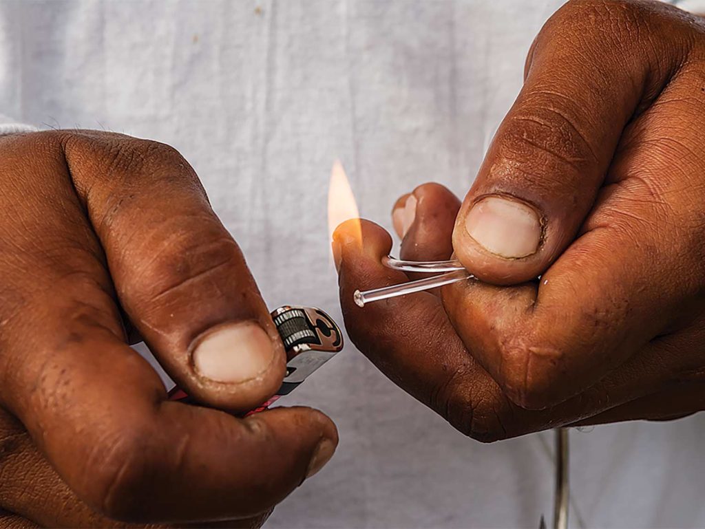 A tag being melted by a small lighter.