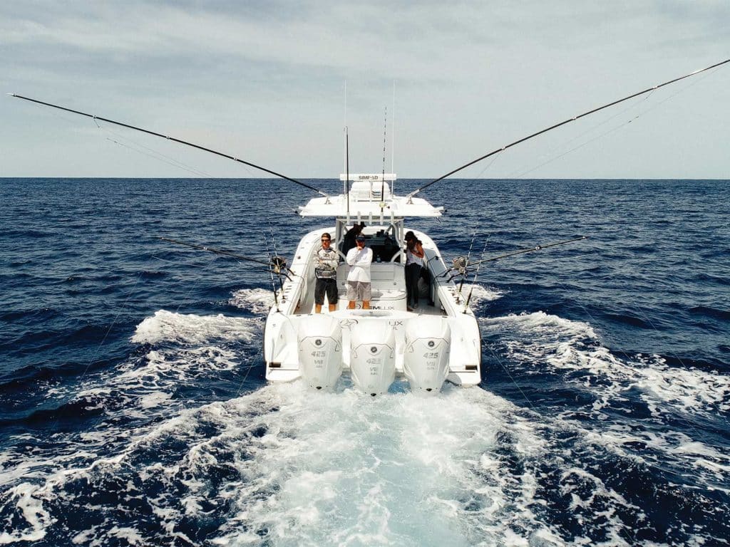 An outboard-motor center console sport fishing boat on the water.