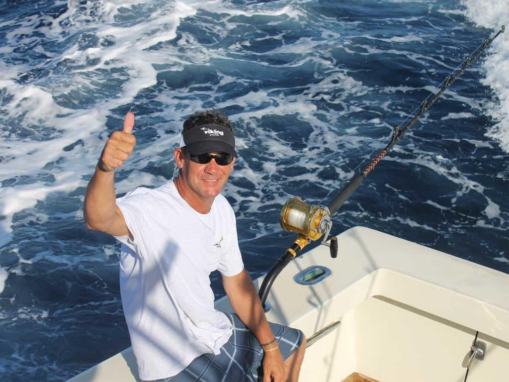 a boat captain giving a thumbs up